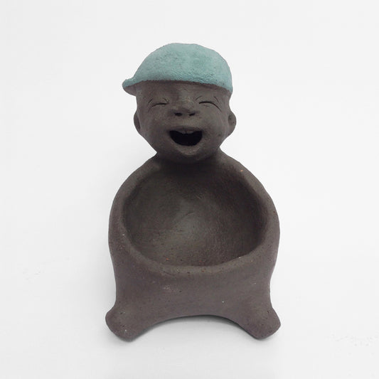 Dark grey ceramic figurine with blue cap.