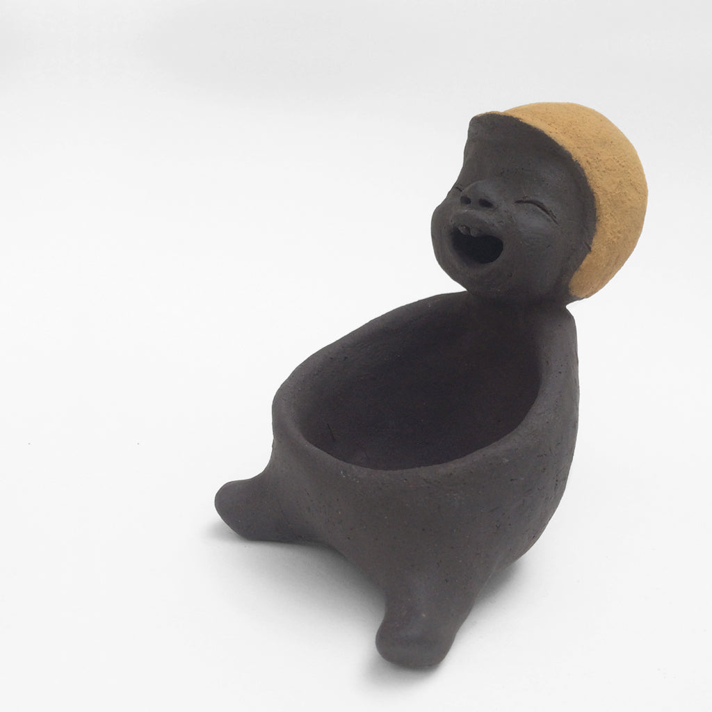Dark grey ceramic figurine with yellow helmet.