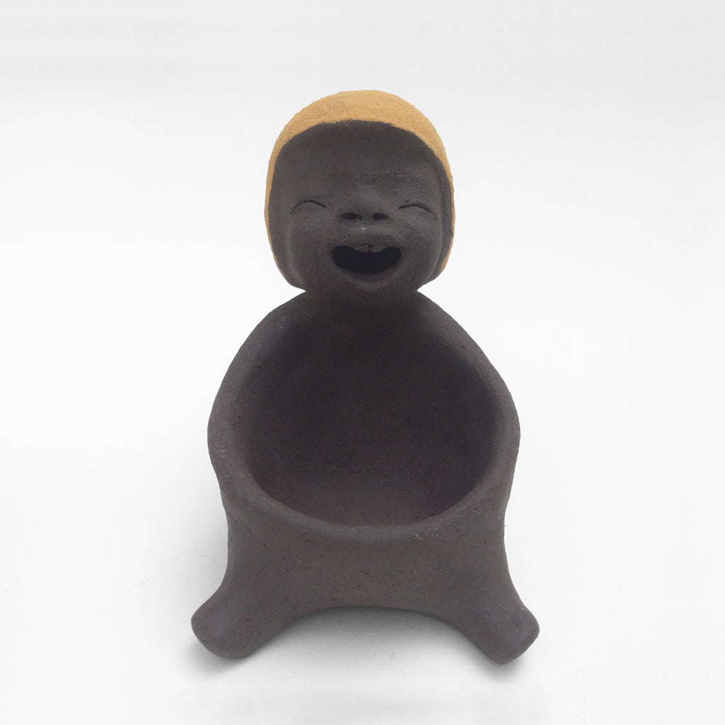 Dark grey ceramic figurine with yellow helmet.