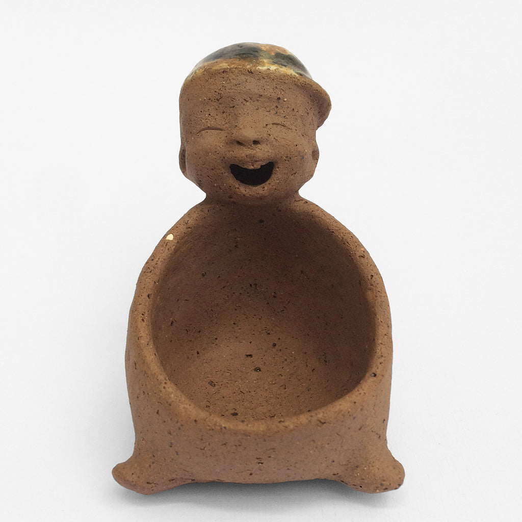 Brown unglazed figurative ceramic object with speckle glazed accent on top