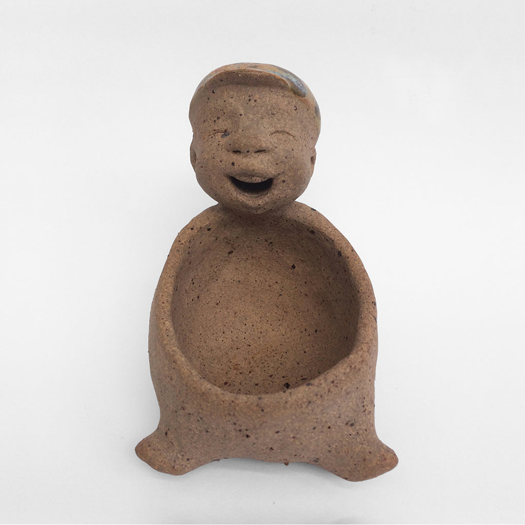 Brown unglazed figurative ceramic object with speckle glazed accent on top
