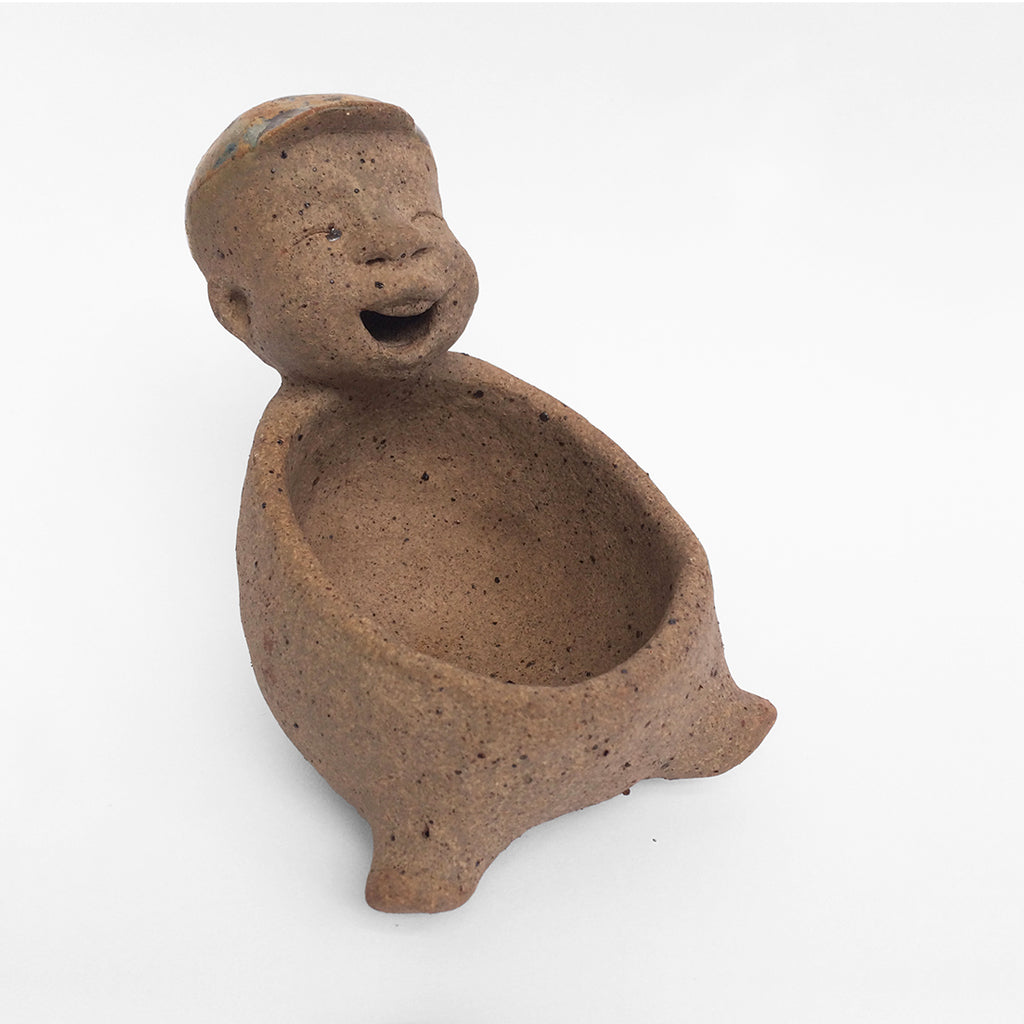 Brown unglazed figurative ceramic object with speckle glazed accent on top