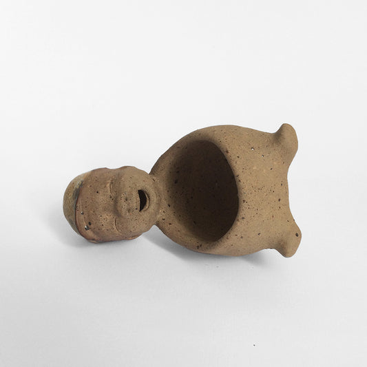 Brown unglazed figurative ceramic object with speckle glazed accent on top