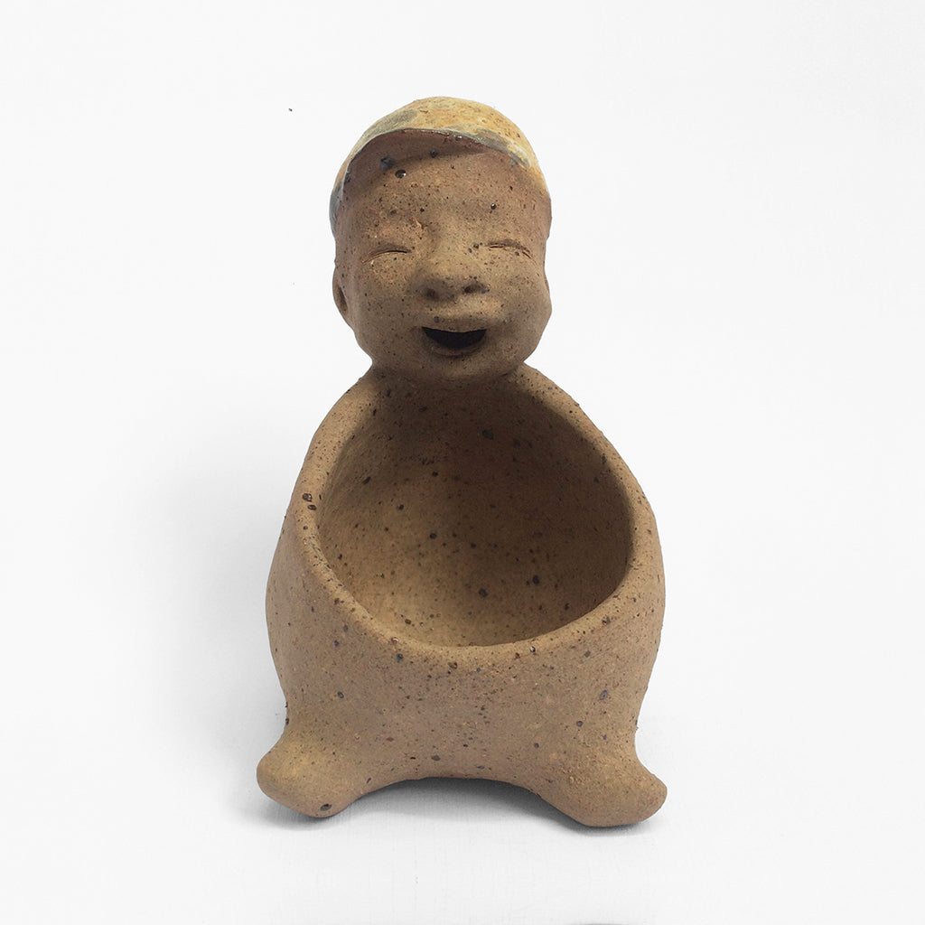Brown unglazed figurative ceramic object with speckle glazed accent on top