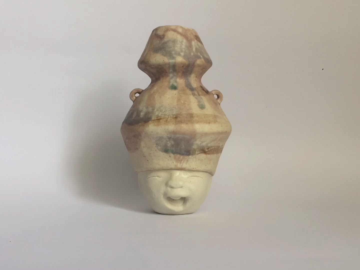 White figurative ceramic sculpture with mixed glazed head 360 video.