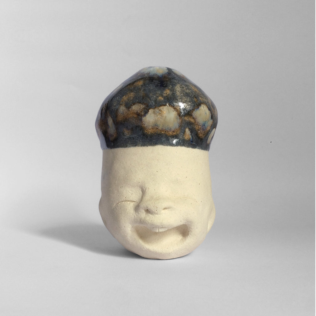 White figurative ceramic sculpture with dark blue abstract glazed head.
