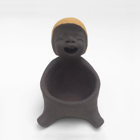 Dark grey ceramic figurine with yellow helmet.