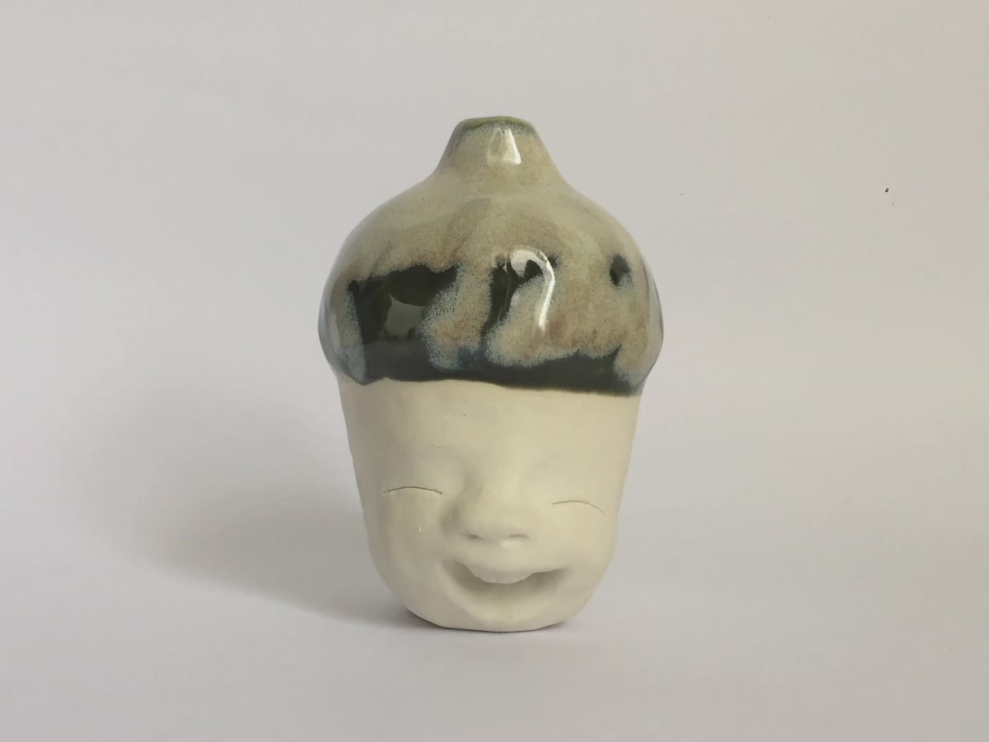 White figurative ceramic sculpture with mixed glazed head.
