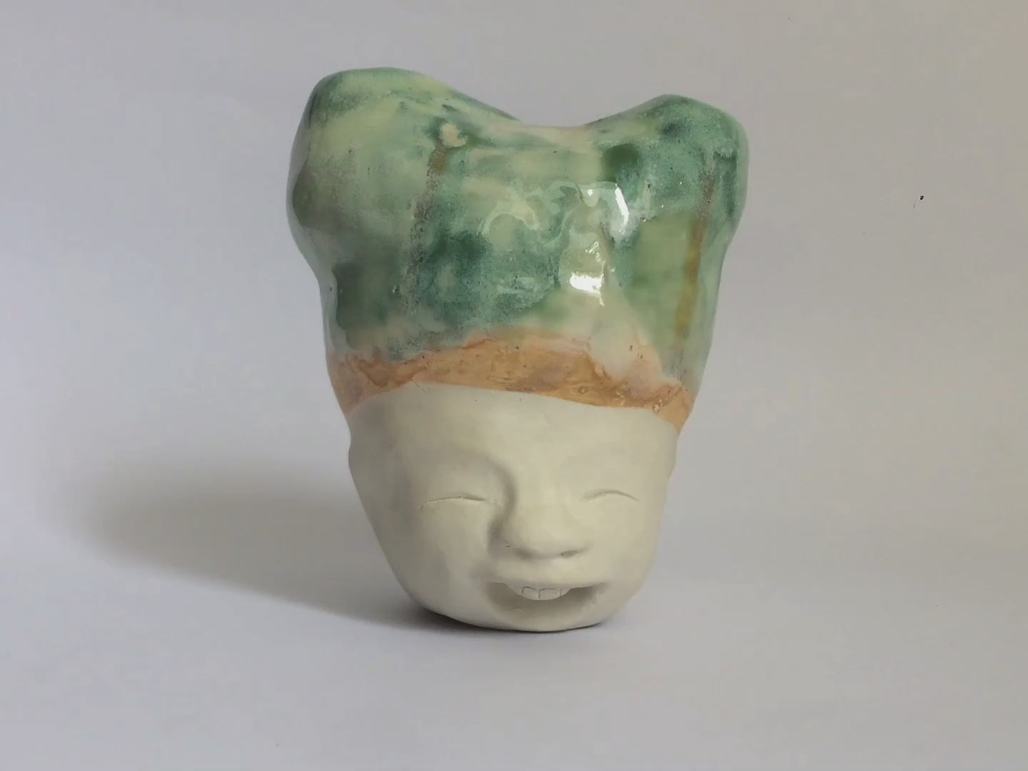 White figurative sculpture with mixed glazed head.