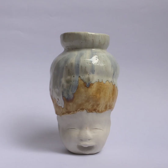 White figurative ceramic sculpture with white caramel glazed head  360 video.