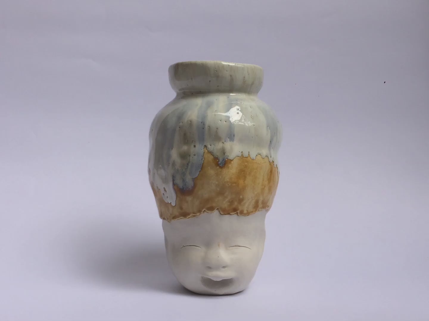 White figurative ceramic sculpture with white caramel glazed head  360 video.