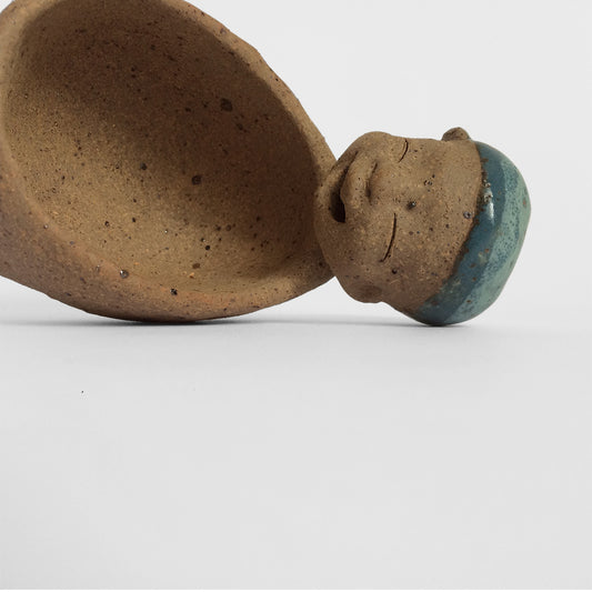 Brown unglazed figurative ceramic object with blue glazed accent