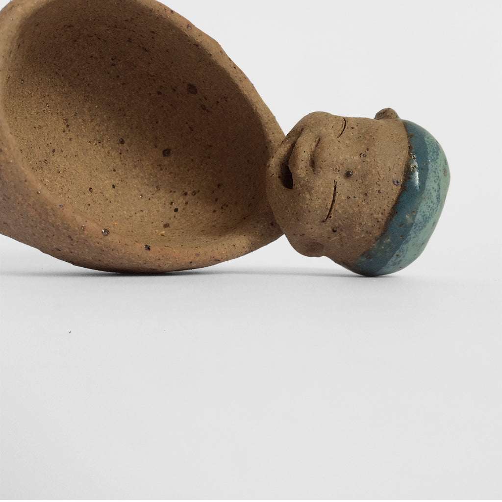 Brown unglazed figurative ceramic object with blue glazed accent 