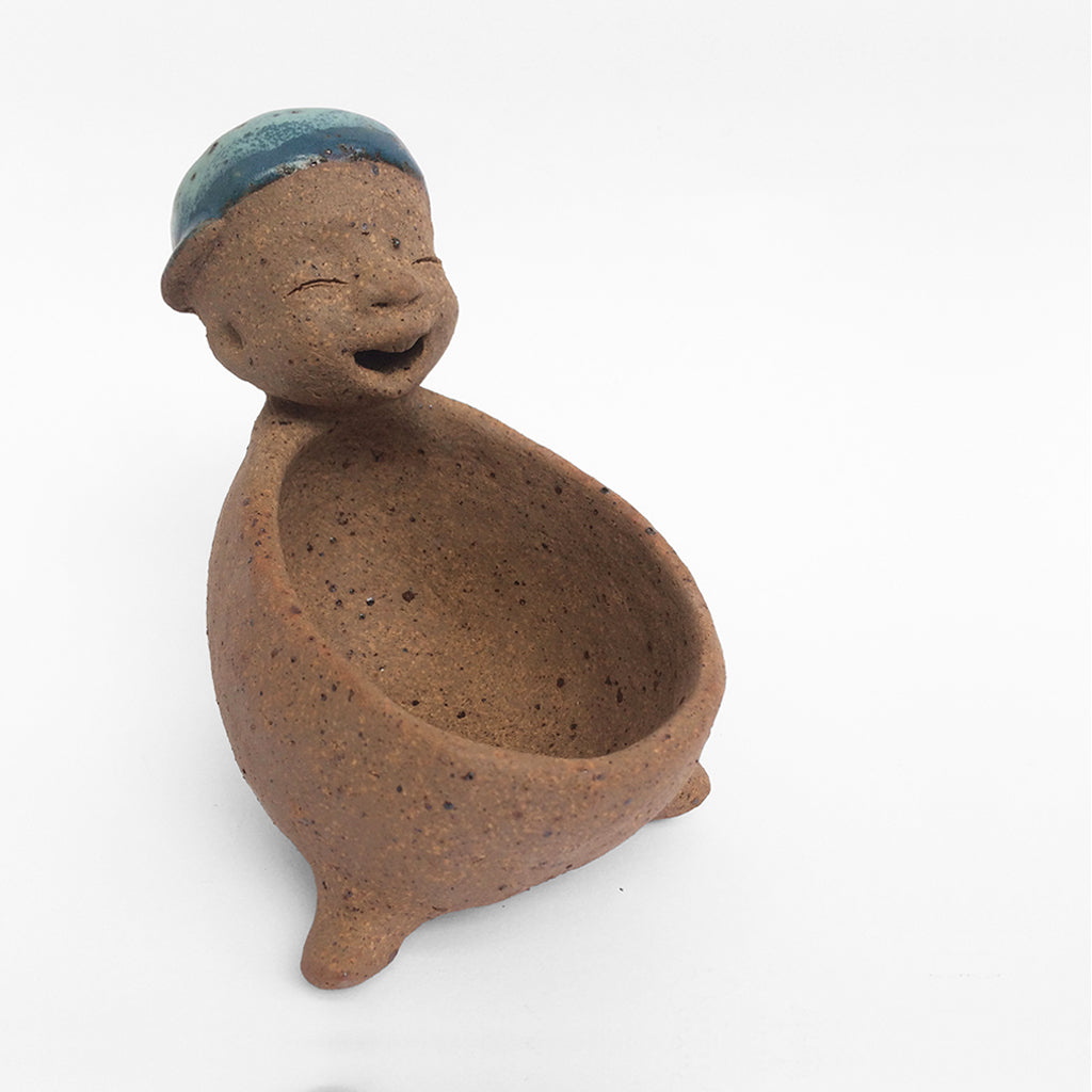 Brown unglazed figurative ceramic object with blue glazed accent on top