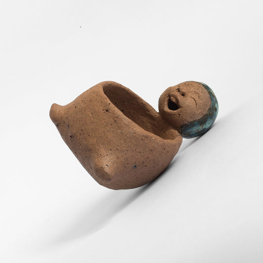 Brown unglazed figurative ceramic object with speckle glazed accent