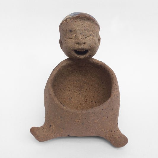 Brown unglazed figurative ceramic object with speckle glazed accent on top