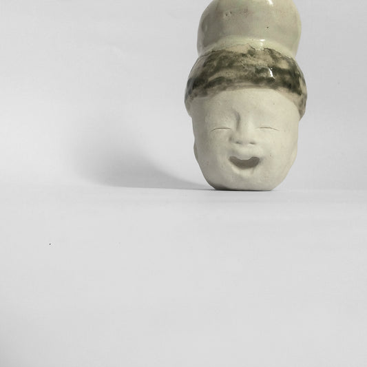 White figurative ceramic sculpture with mixed glazed head.