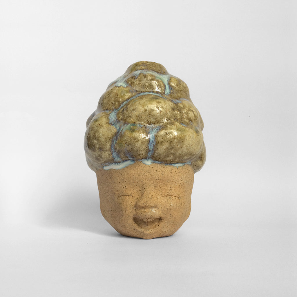 Brown figurative ceramic sculpture with brown glazed head facing front.