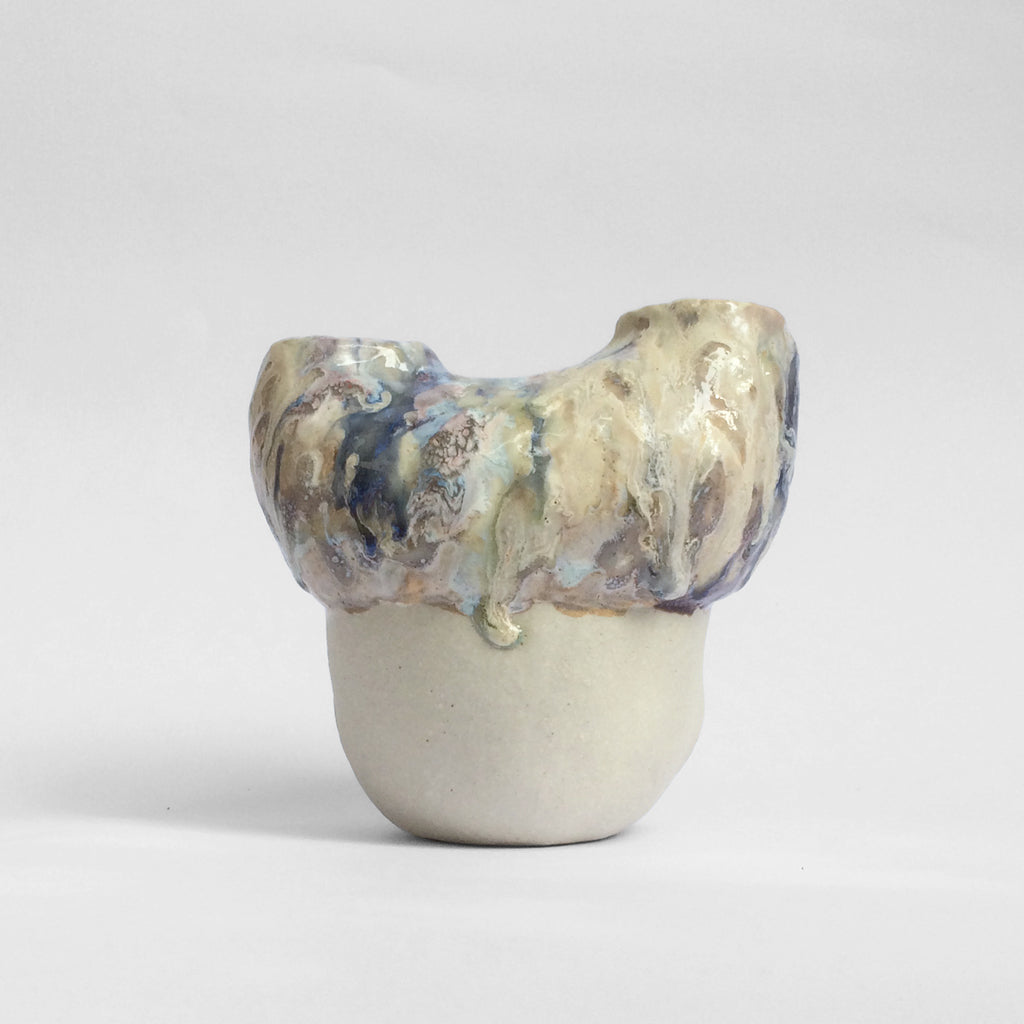 White figurative ceramic sculpture with abstract purple glazed head  from the back.